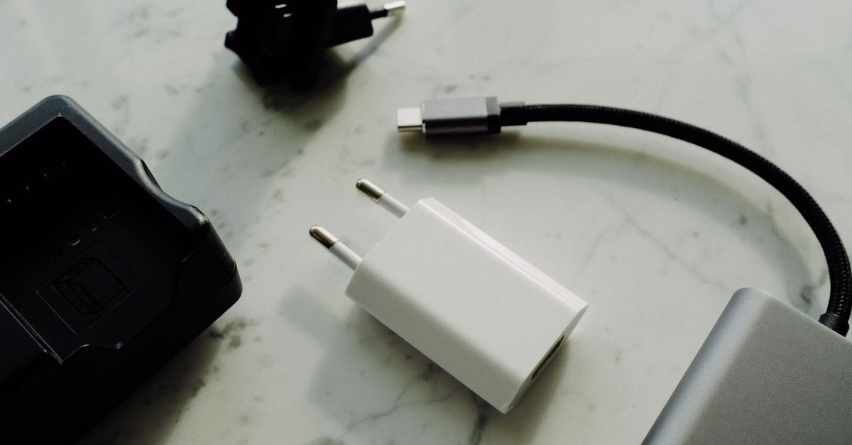 Hardware wallet connected by cable to a laptop for signing